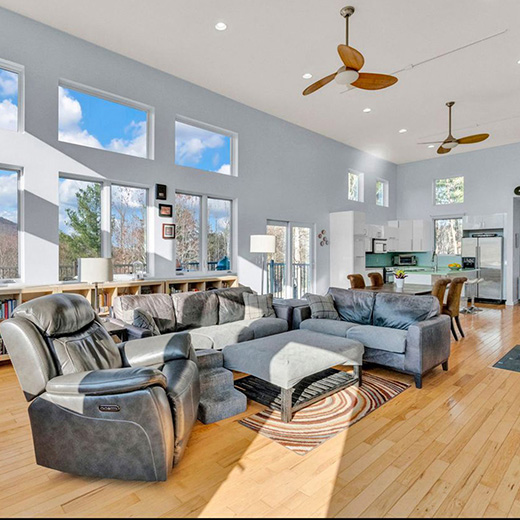 sectional sofa and recliner in a open flooplan living room with very tall ceilings<br />
