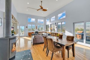 the rotating wood stove is the centerpiece of the dining area that flows out of the great room
