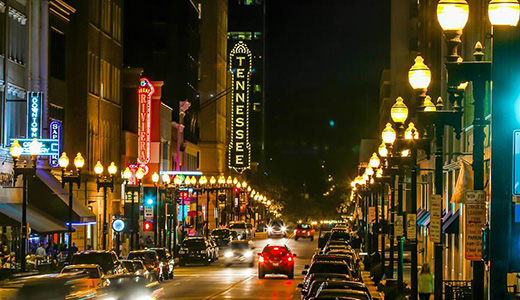 nighttime photo of downtown knoxville with the marquee of the Tennessee theater in lights