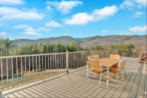 Golden hour image of deck overlooking an endless mountain range