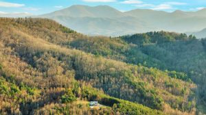 very high overhead shot of the house shows the nearby mountain ranges as well as the giant North Carolina mountains in the background