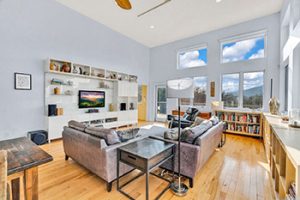 living room with entertainment center and wall of windows