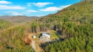 Drone shot of contemporary styled house with large deck and solar panels