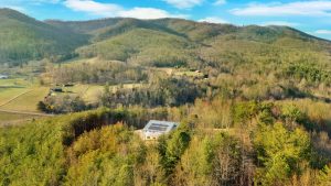 Overhead photo of house with silver metal roof and a large solar panel array