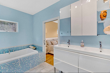Spa-style master bathroom with oversized soaker tub and double vanity