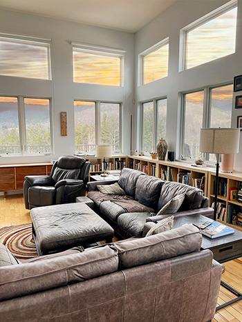 snapshot of dramatic sunset light through a wall of glass in a living room