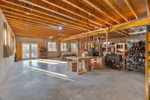 Wide open lower level features multiple large windows and 10 foot wide glass French doors