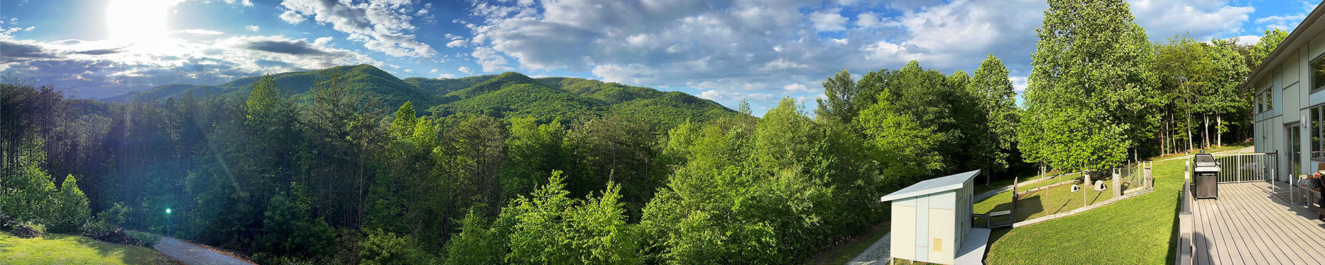 panorama photo of house and mountains and wide lawn<br />
